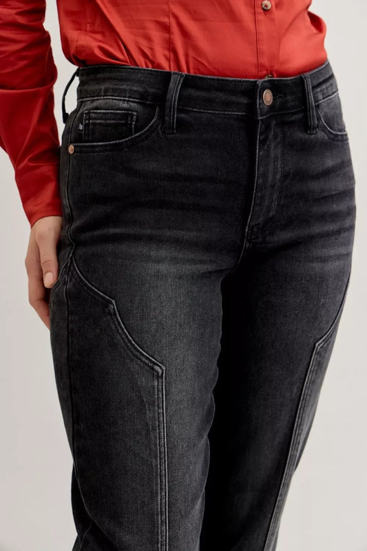 Black high-rise jeans with curved seam detail and front pockets, styled with a red blouse.