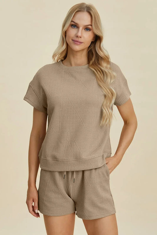 Woman wearing a textured taupe short-sleeve top and matching shorts set, relaxed fit