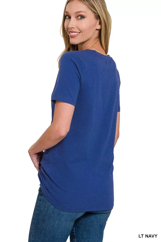 Woman modeling casual light navy short sleeve t-shirt with relaxed fit and blue denim jeans