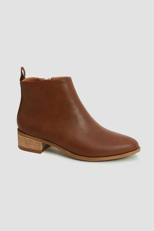 Brown leather ankle boot with low stacked heel on light background