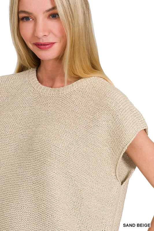 Woman wearing sand beige knit sleeveless top with relaxed silhouette