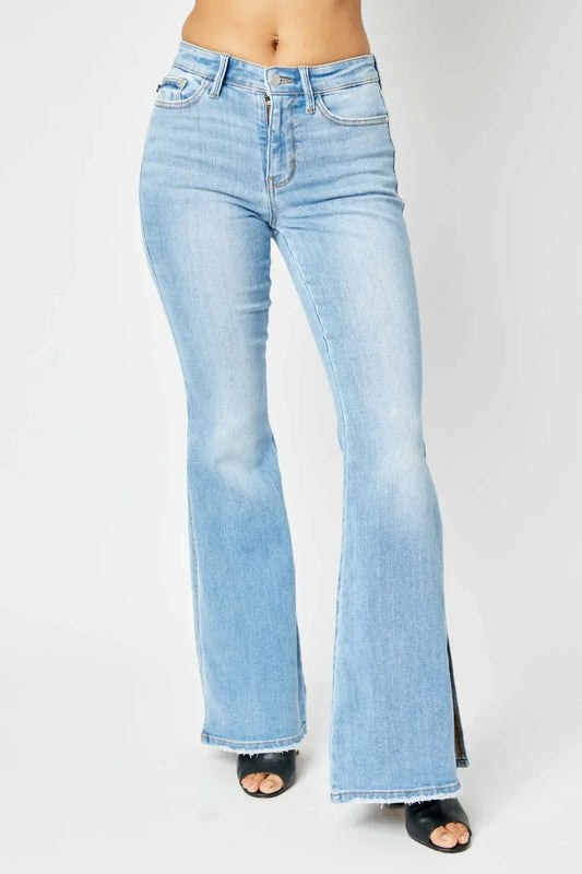 Light wash high waisted flare jeans with raw hem, styled with black open-toe heels.
