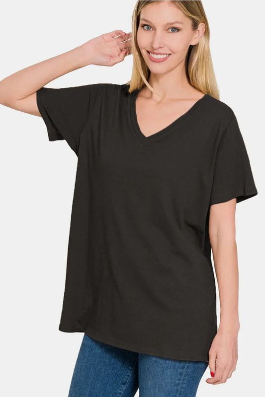 Woman wearing a relaxed black V-neck short sleeve top with blue jeans