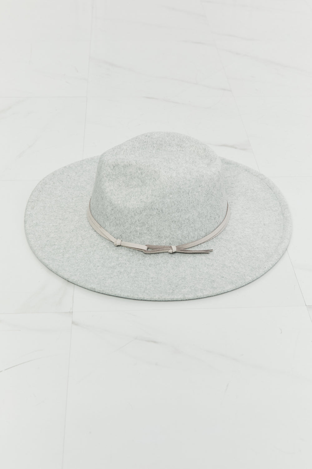 a wide brim Gray felt fedora hat with a leather tie detail on a white background