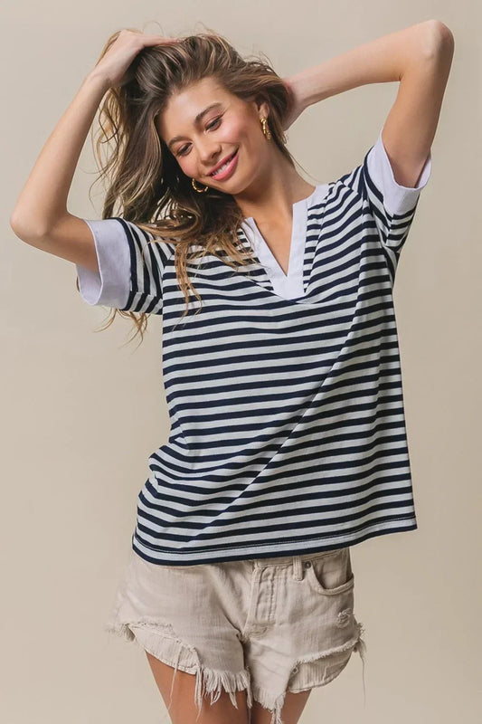 Woman wearing navy and white BiBi Contrast Striped Notched Knit Top with white trim and beige frayed shorts
