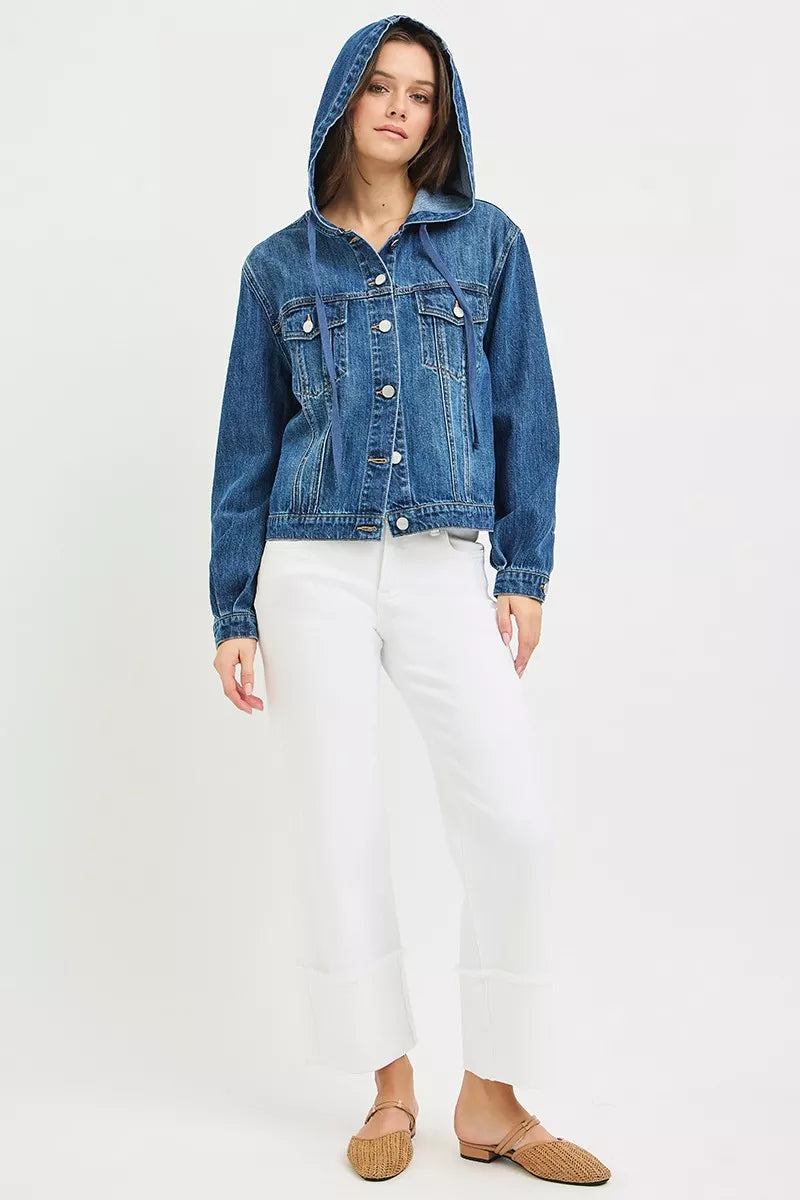 woman wearing a button-up Denim Jacket with Hoodie, white tank top and white jeans, and tan slip-on flats in front of a white background