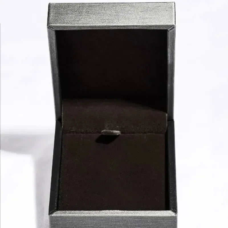Empty elegant black velvet jewelry box with open lid on a white background