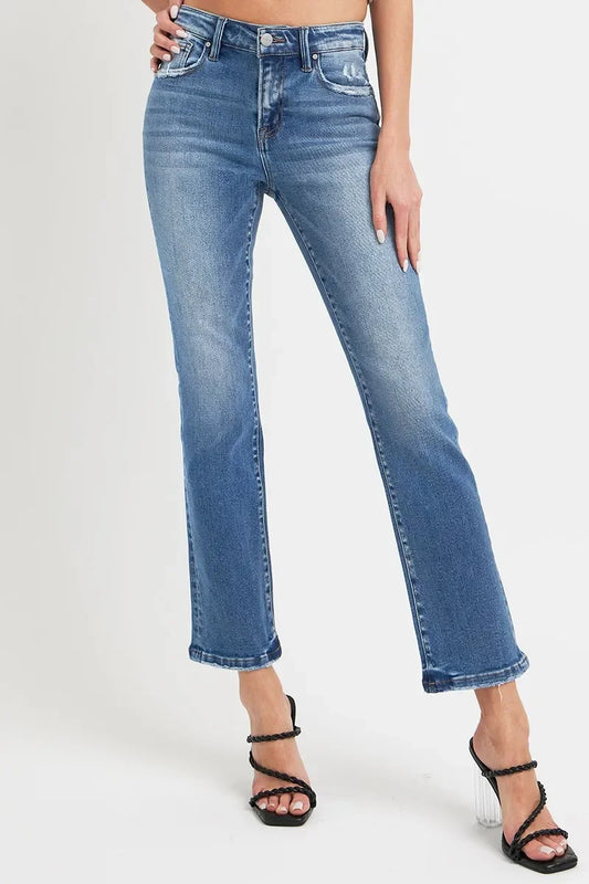 Woman wearing high-waisted straight leg blue jeans with black heeled sandals