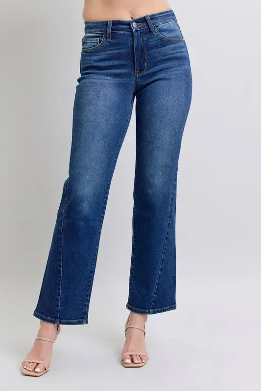 Woman wearing high-waisted straight leg blue jeans and nude heeled sandals