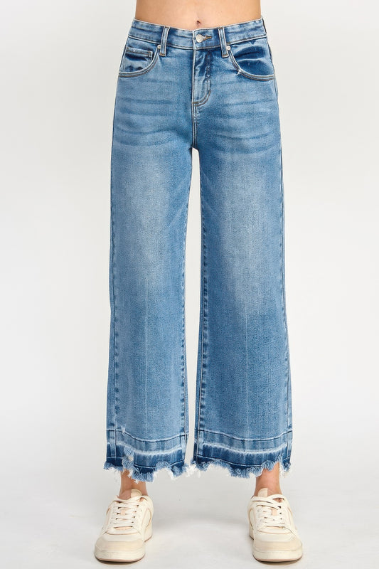Tummy Control Cropped Wide Leg Jeans with a frayed hem worn by a person in white sneakers on a white background