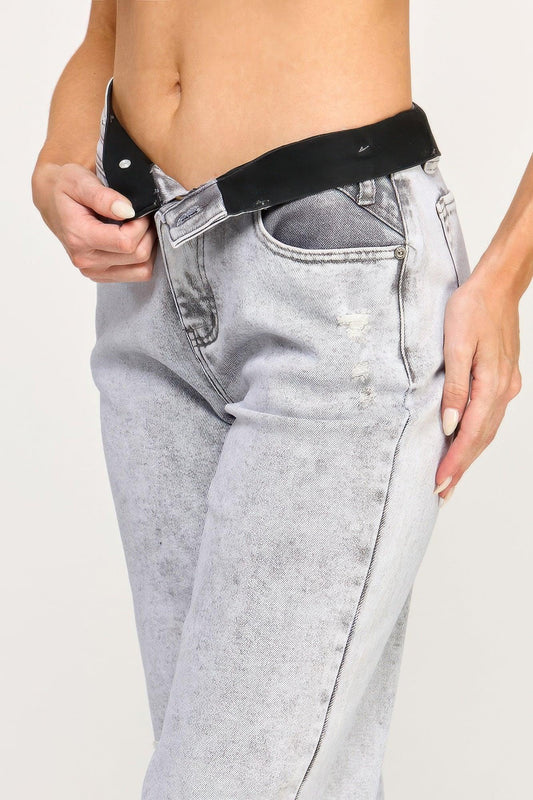 Light wash high-waisted jeans with a black waistband and distressed detailing