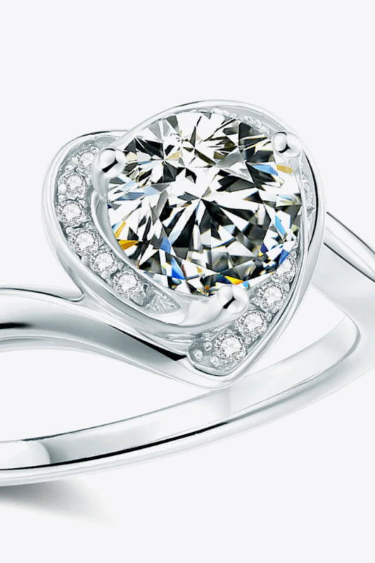Close-up of a silver ring with a large round center stone and smaller accent diamonds