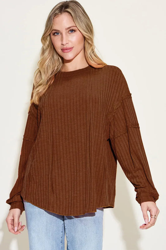 Woman wearing a relaxed-fit brown ribbed long sleeve top with light wash jeans