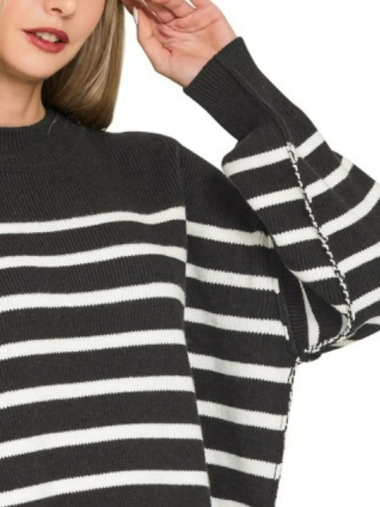Woman wearing black and white striped knit sweater with relaxed sleeves
