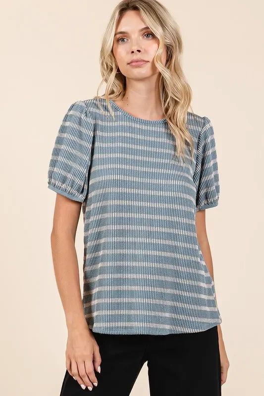 Woman wearing a short sleeve blue and white striped blouse with puff sleeves