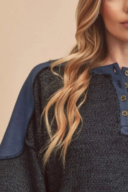 Textured navy pullover with buttoned collar and long sleeves, featuring contrast shoulder detail.