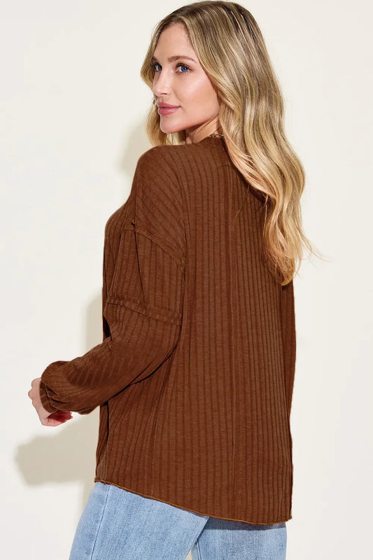 Woman wearing a relaxed brown ribbed long sleeve top with light wash jeans