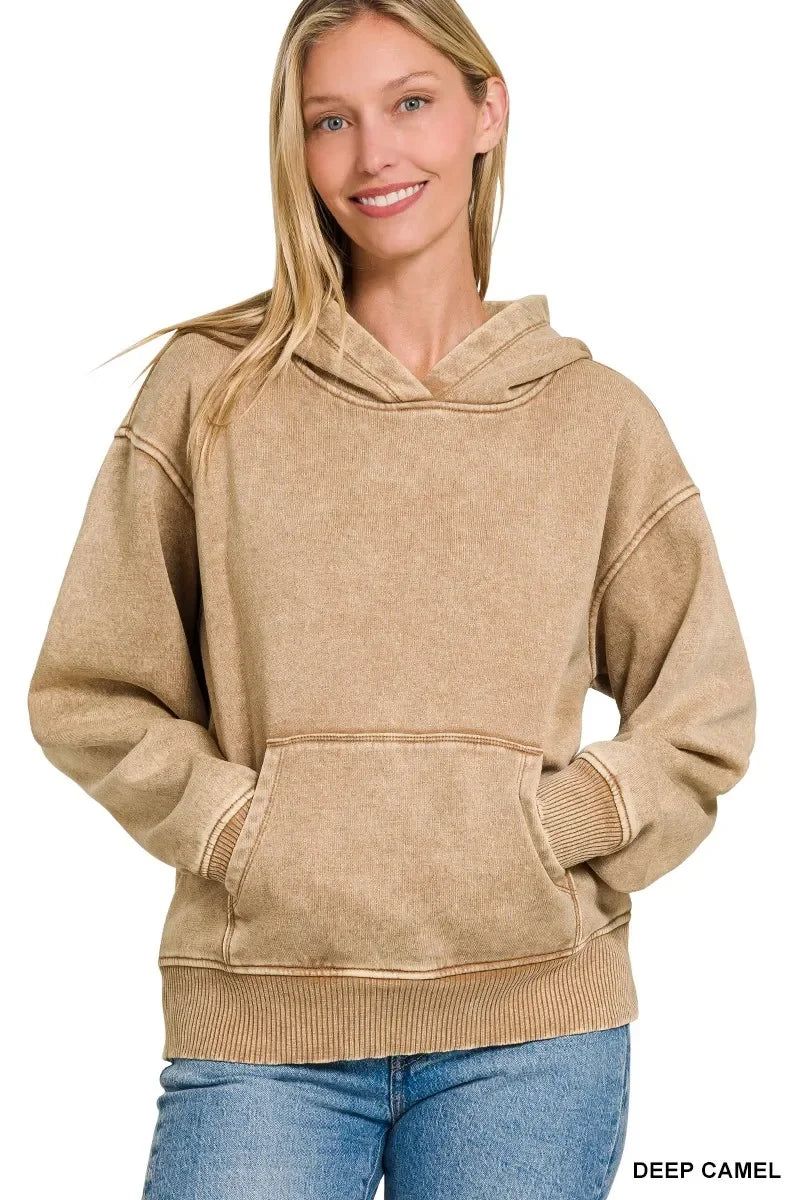 Woman wearing a deep camel hooded sweatshirt with kangaroo pocket and relaxed fit