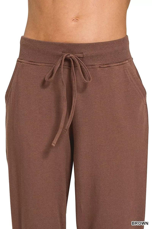 Brown drawstring high-waisted sweatpants with side pockets, relaxed fit