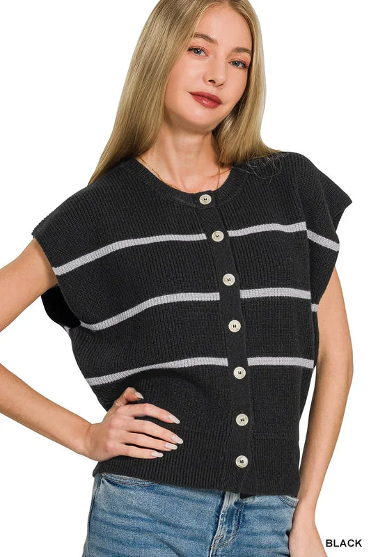 Woman wearing a black ribbed knit button-up vest with white horizontal stripes and blue jeans