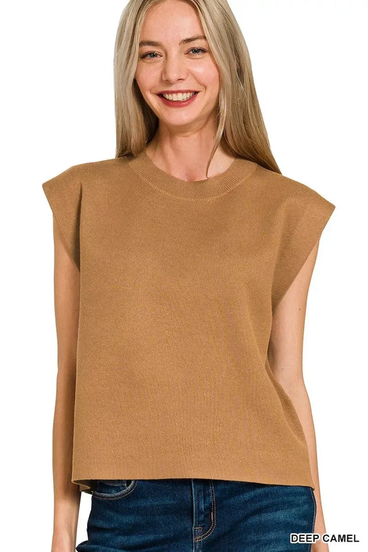 Woman wearing sleeveless deep camel knit top with relaxed fit and crew neckline