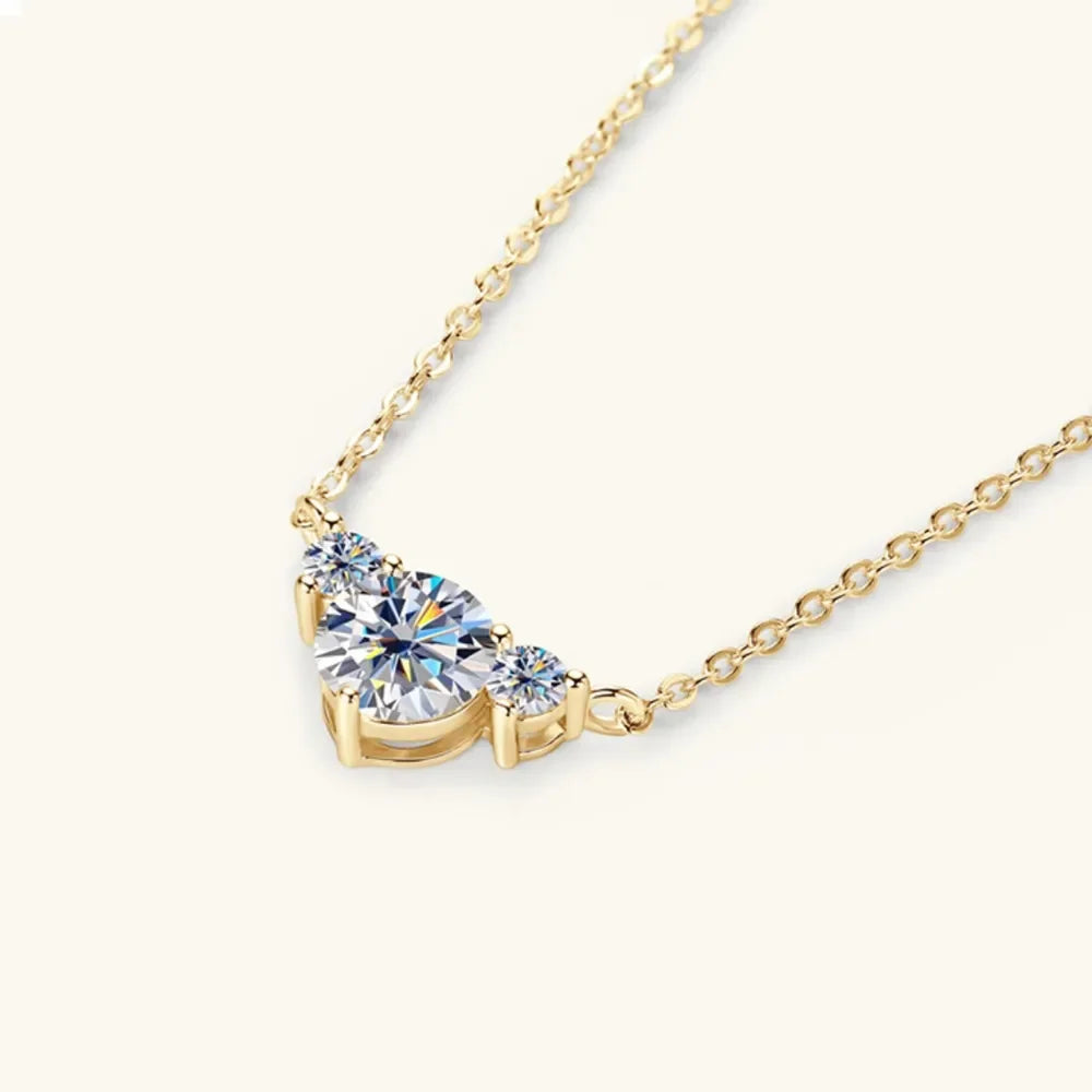 Gold chain necklace with three round clear gemstones, minimalist and elegant design