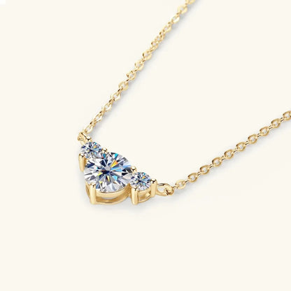 Gold chain necklace with three round clear gemstones, minimalist and elegant design