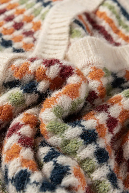 Close-up of soft knit sweater with colorful checkered pattern and ribbed cream collar.