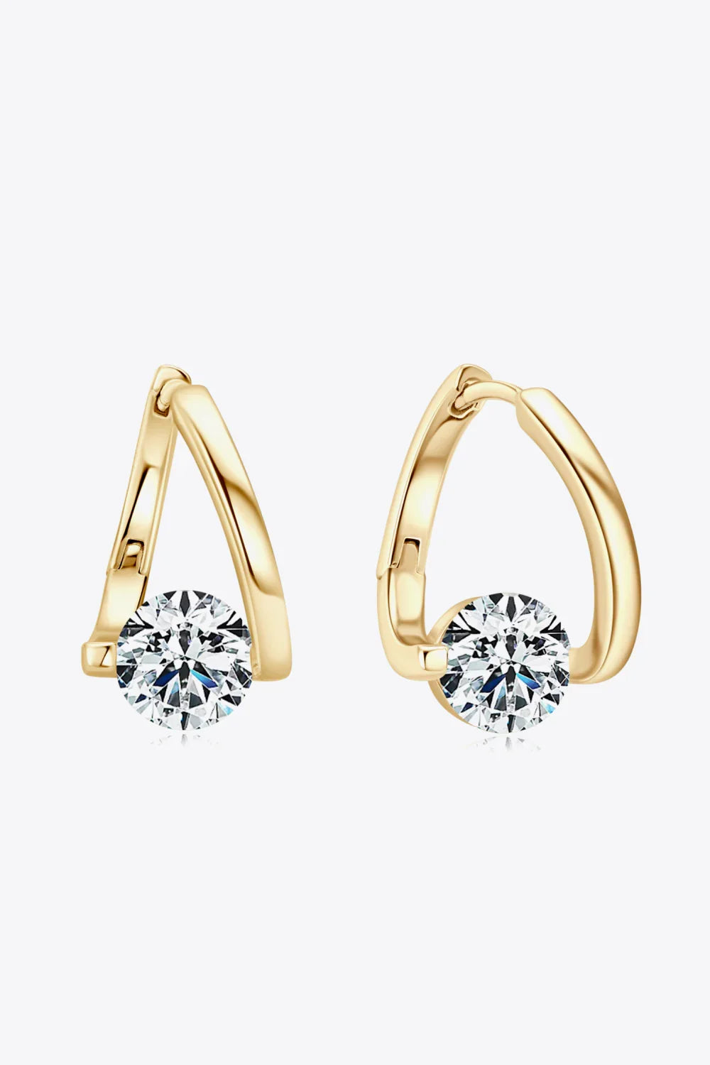 Gold hoop earrings with round clear gemstones, modern minimalist jewelry on white background.