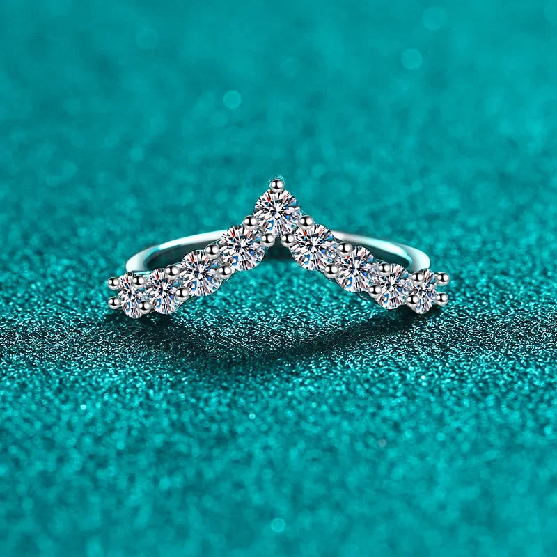 Silver chevron diamond ring with round stones on sparkling turquoise background