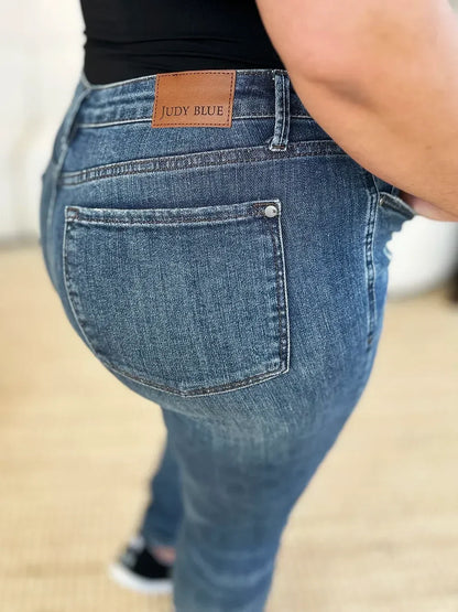 Close-up of Judy Blue high-waisted blue denim jeans with back pocket and leather patch.