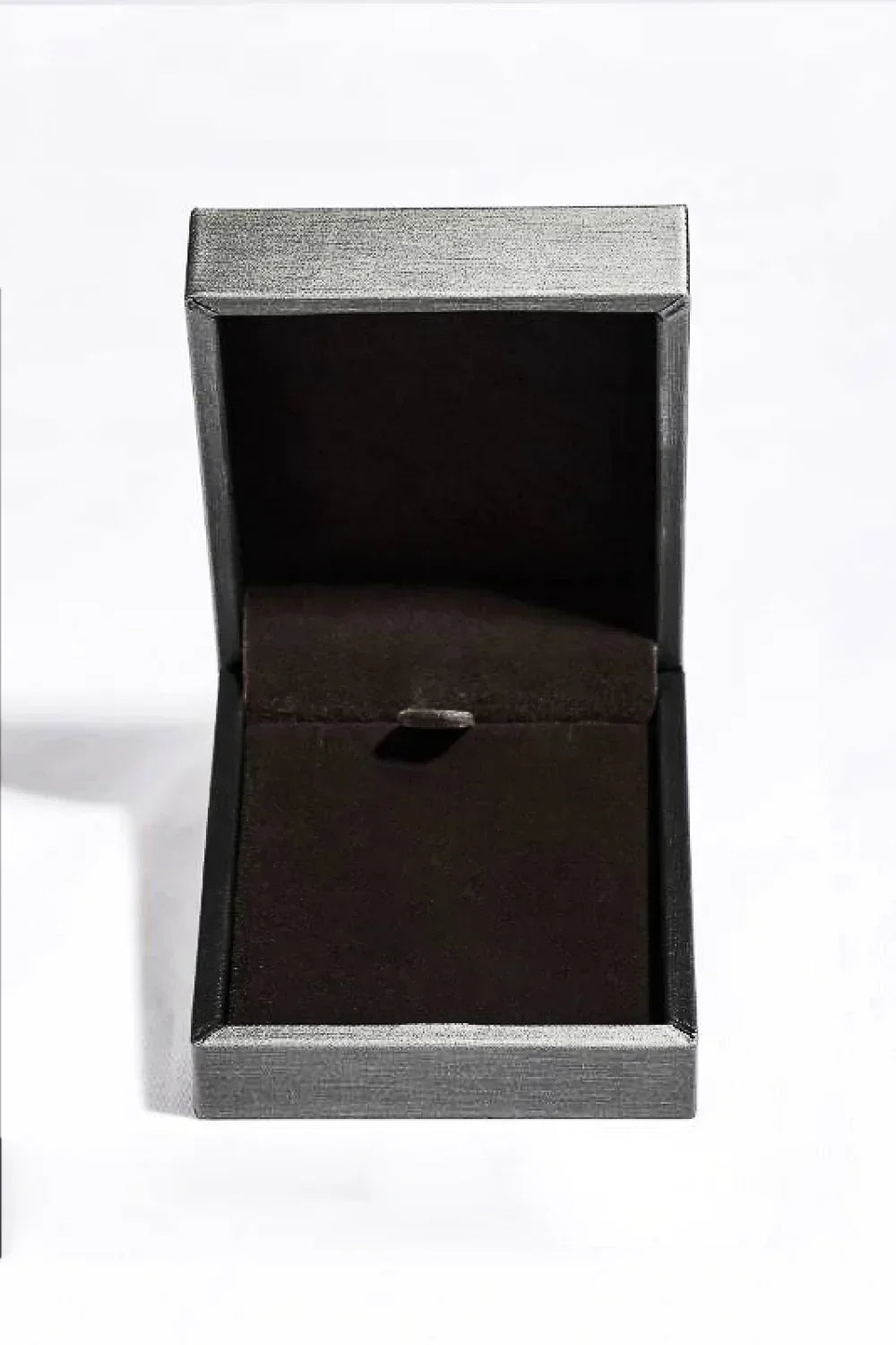 Empty black velvet jewelry box with hinged lid on a white background