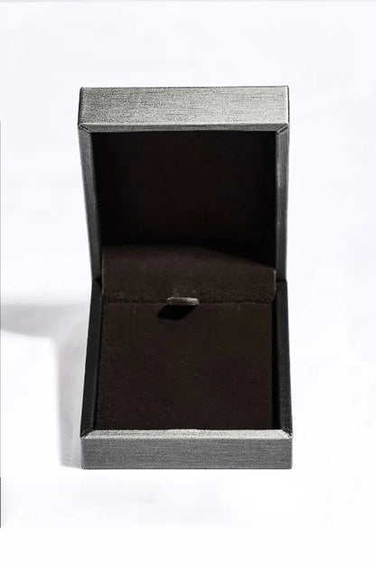 Empty black velvet jewelry box with hinged lid on a white background