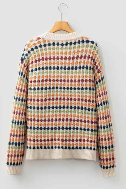 Back view of a multicolor patterned knit sweater with ribbed collar and cuffs, hanging on a wooden hanger.