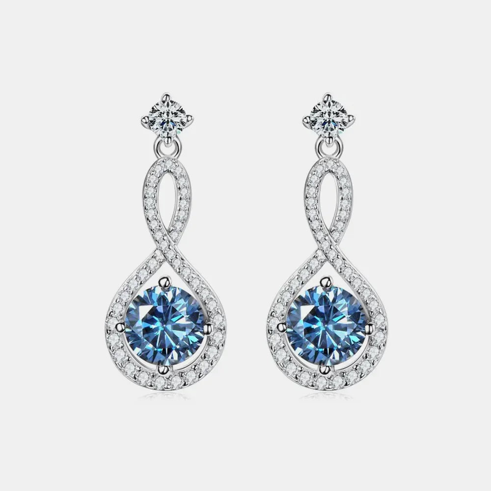 Elegant silver dangle earrings with blue gemstones and clear crystal accents on white background.
