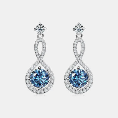 Elegant silver dangle earrings with blue gemstones and clear crystal accents on white background.