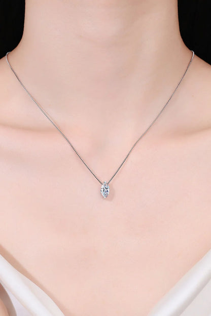 Delicate silver chain necklace with marquise-cut crystal pendant on model's neck