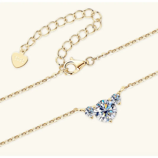 Gold chain necklace with lobster clasp and three round clear gemstones, elegant minimalist jewelry