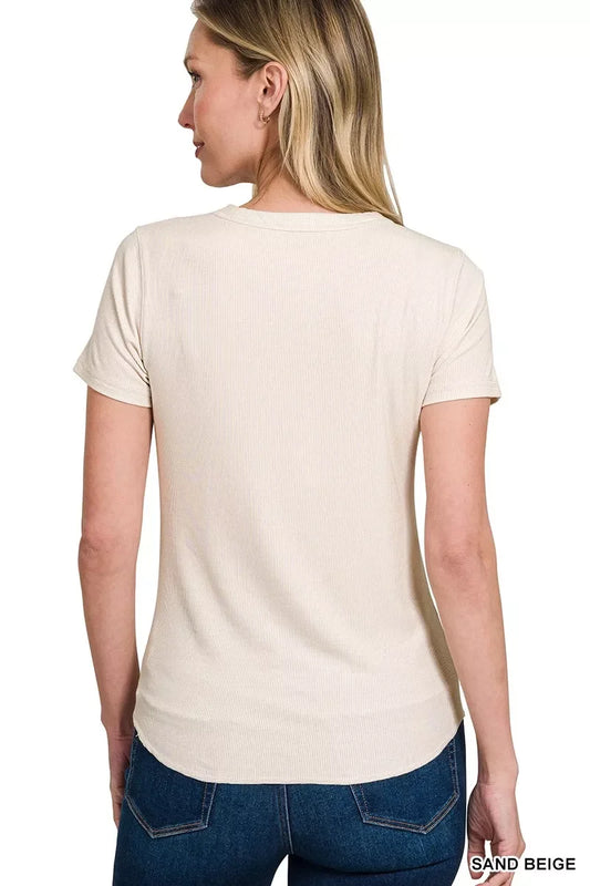 Woman wearing a sand beige ribbed short sleeve t-shirt with blue jeans, back view