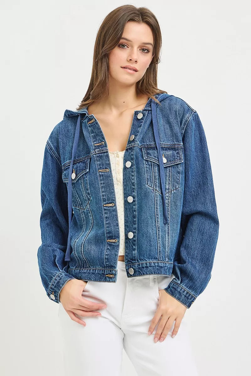 woman wearing a button-up Denim Jacket with Hoodie, white tank top and white jeans on a white background