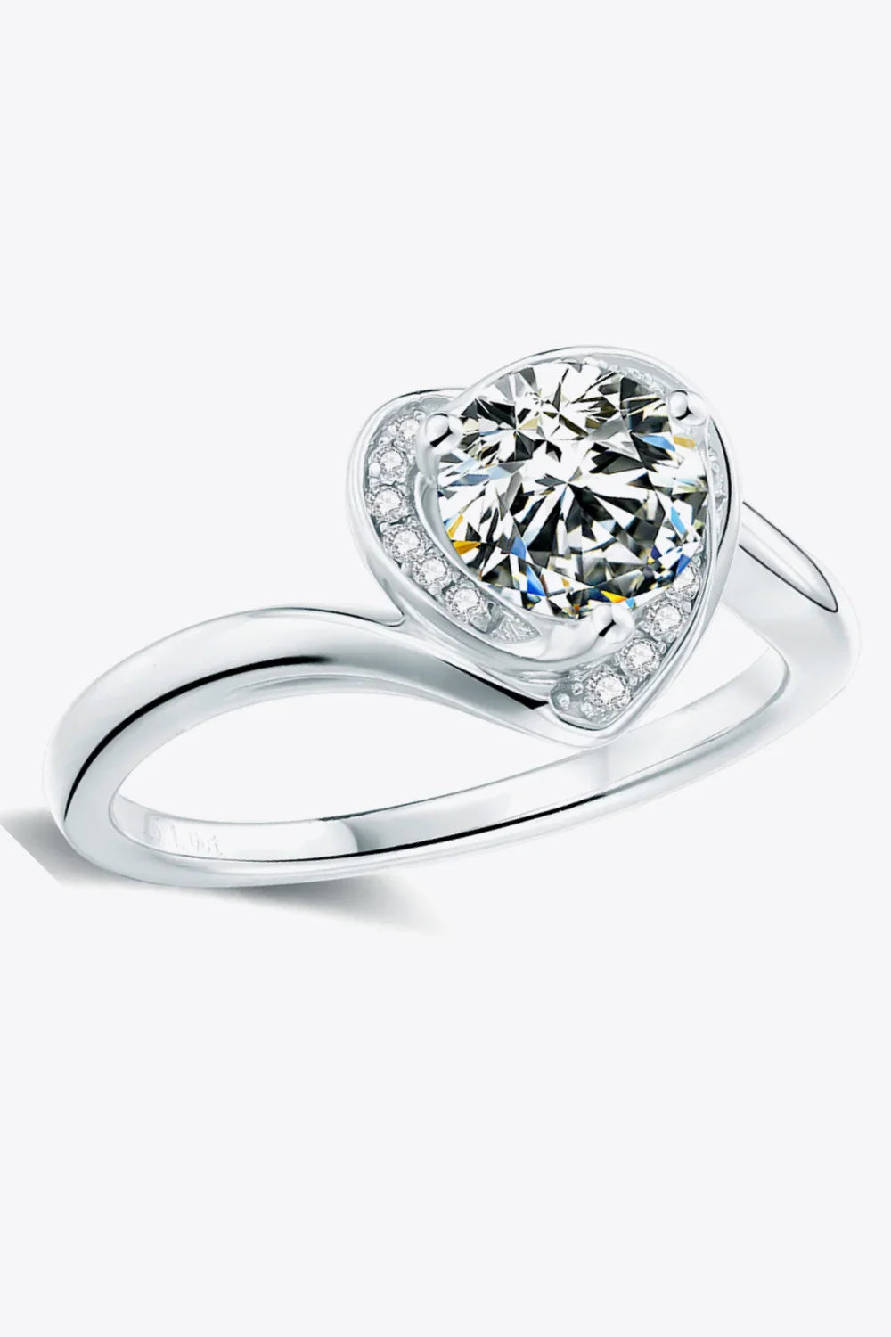Silver heart-shaped ring with large center stone and pavé accent diamonds on white background