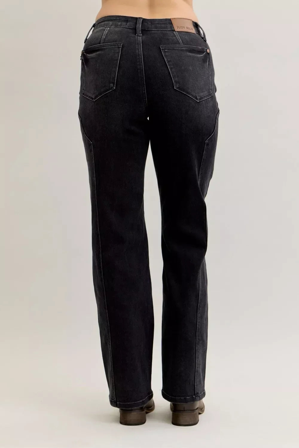 Back view of high-rise, straight-leg black denim jeans with patch pockets