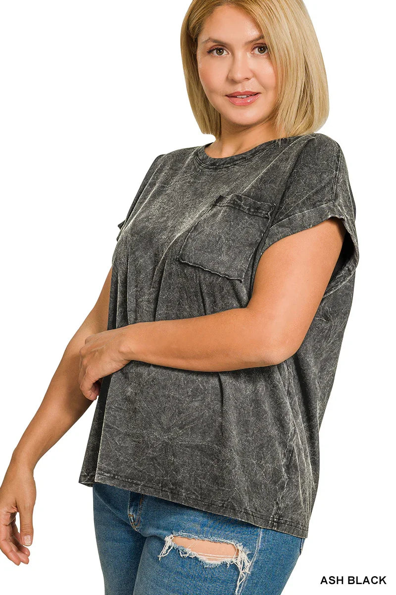 Woman wearing an ash black washed oversized t-shirt with chest pocket and relaxed blue jeans