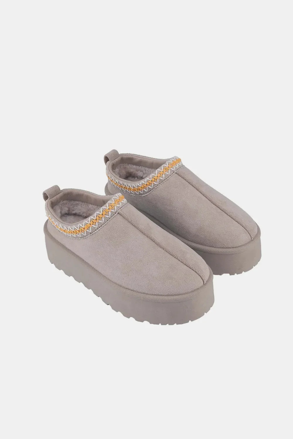 Taupe suede slip-on platform shoes with cozy lining and chevron trim detail