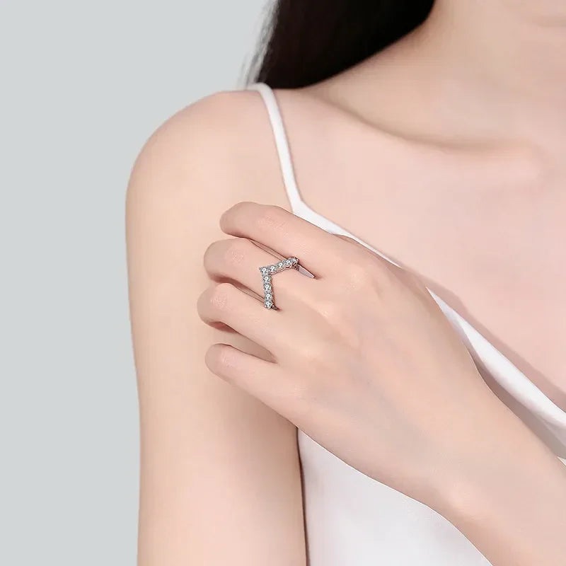Woman wearing a silver chevron crystal ring on her hand, minimalist fashion jewelry