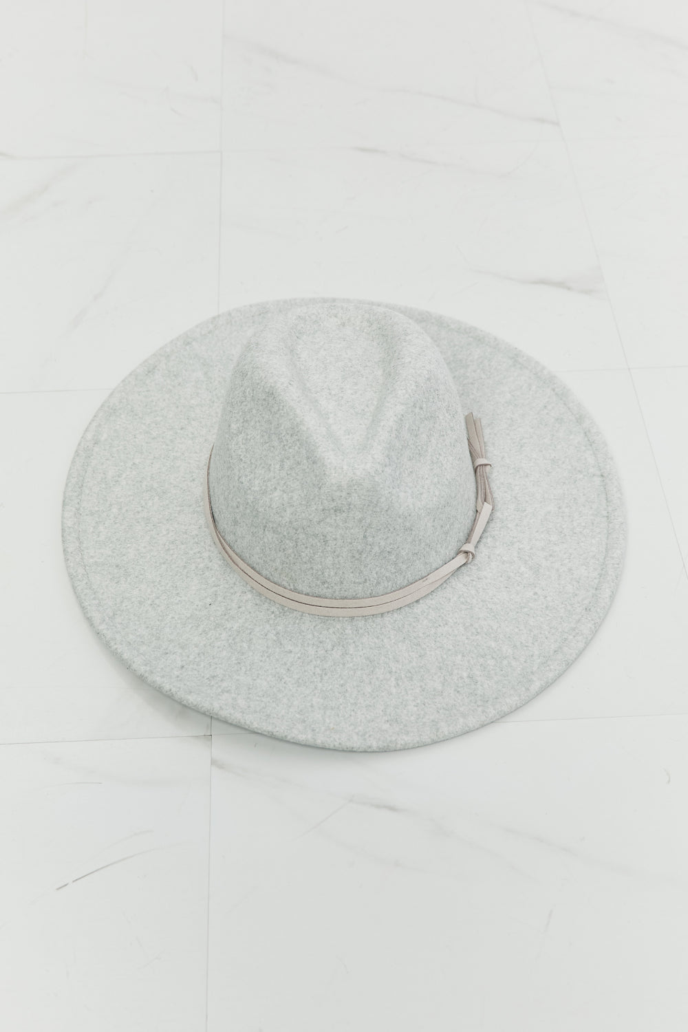 a wide brim Gray felt fedora hat with a leather tie detail on a white background