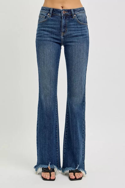High-waisted flared jeans with raw hem detailing, styled with sandals on a neutral background.
