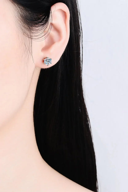 Close-up of a woman's ear wearing a sparkling crystal stud earring
