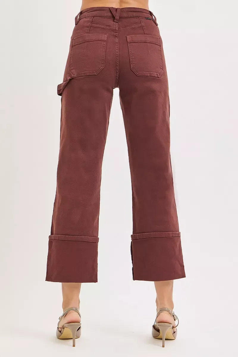 Back view of high-waisted, wide-leg burgundy cropped pants with patch pockets and cuffed hems.