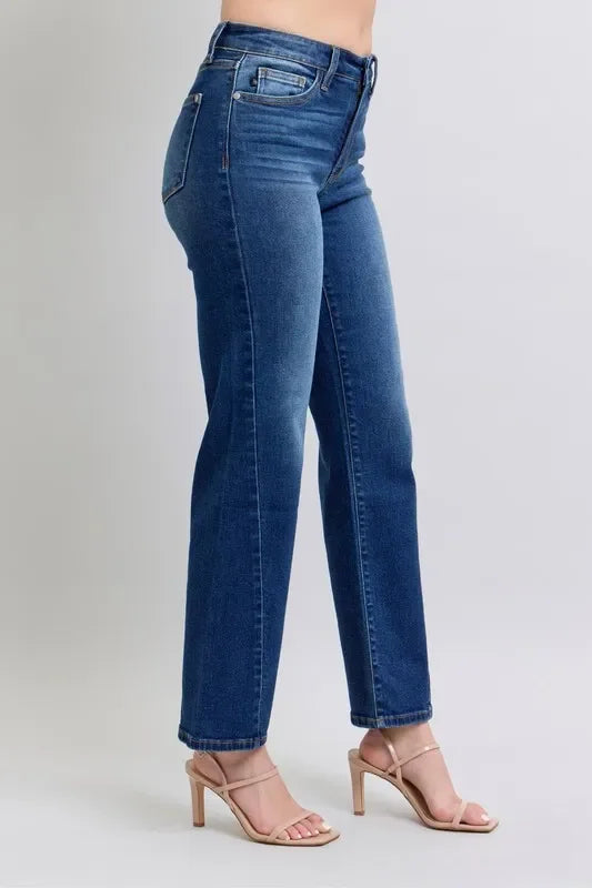 Woman wearing high-waisted straight leg blue jeans and nude heeled sandals